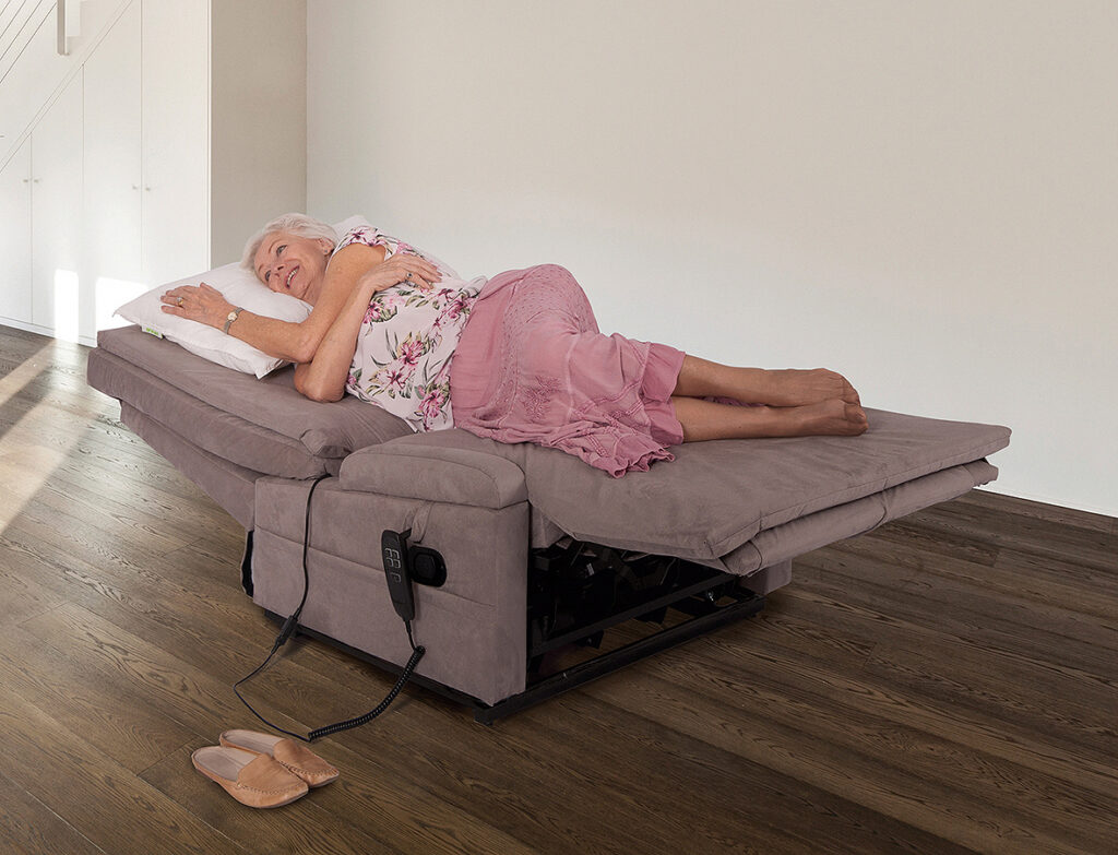 Woman laying on a reclining wide chair bed