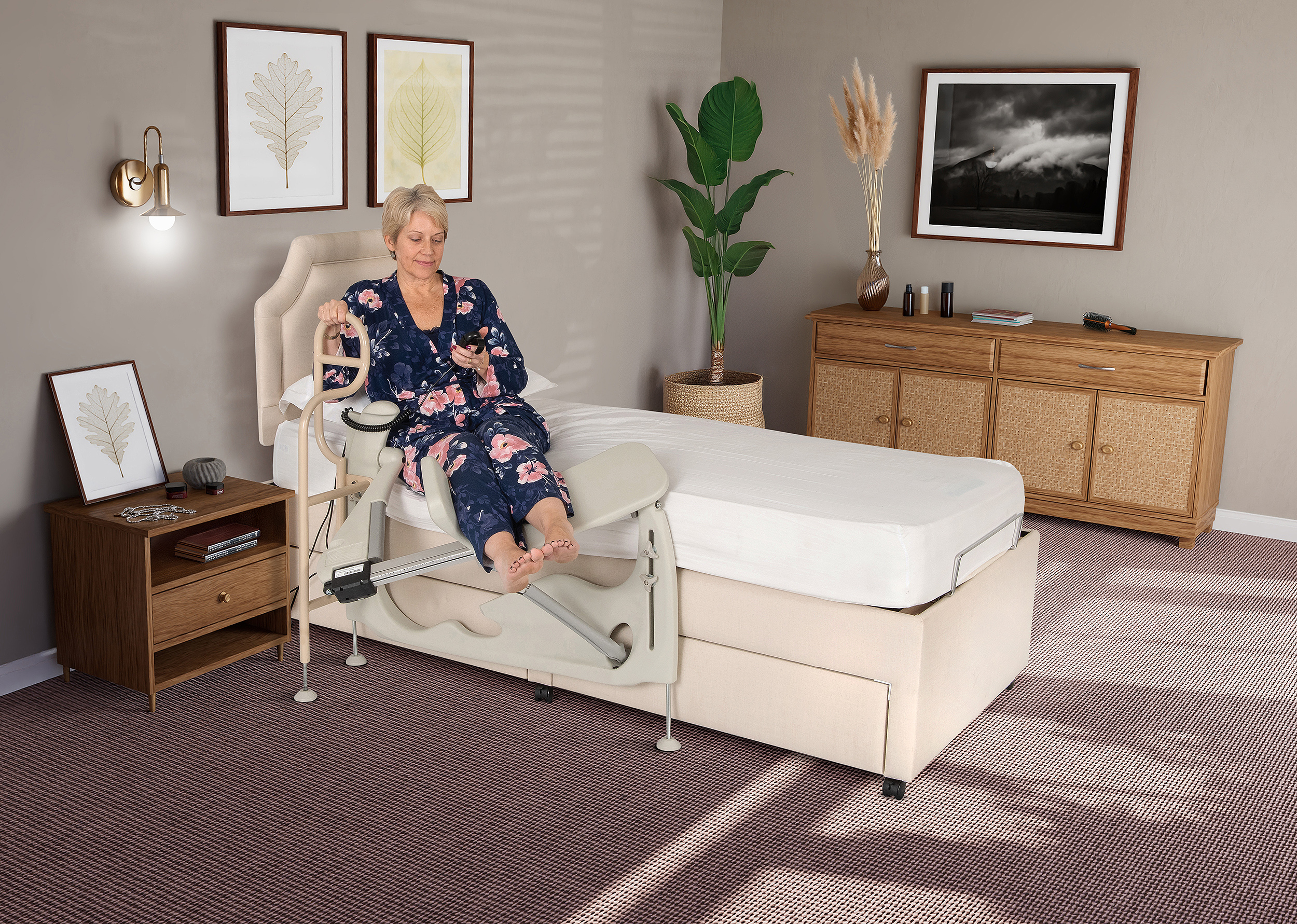 Woman sat on a bed in a bedroom with legs resting on a leg lifting device