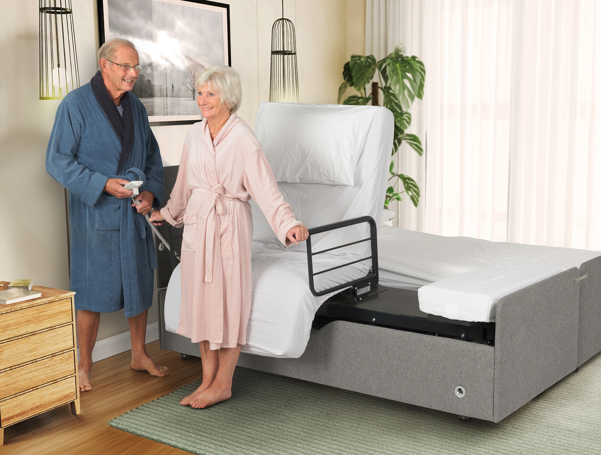 Couple standing next to their Orbit rotating adjustable double bed