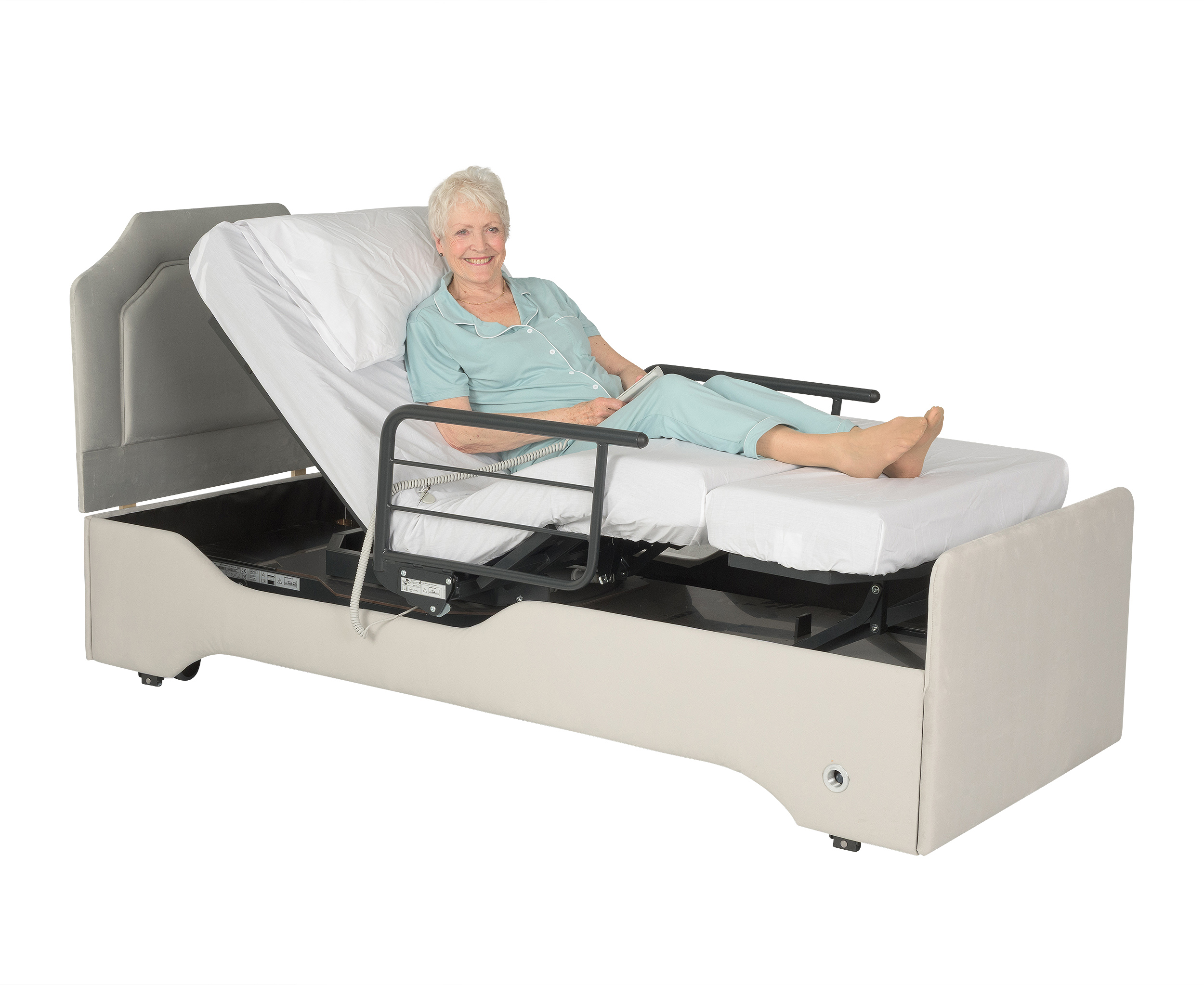 Elderly woman in an Orbit 235X single adjustable divan bed with raised backrest and height adjustable heel support